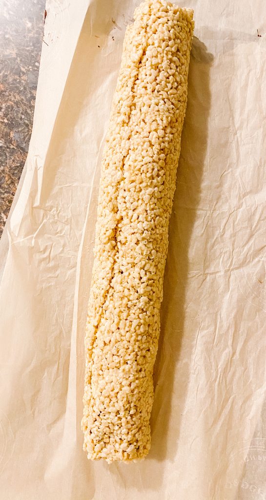 Roll up the Rice Krispies and toppings into a log.