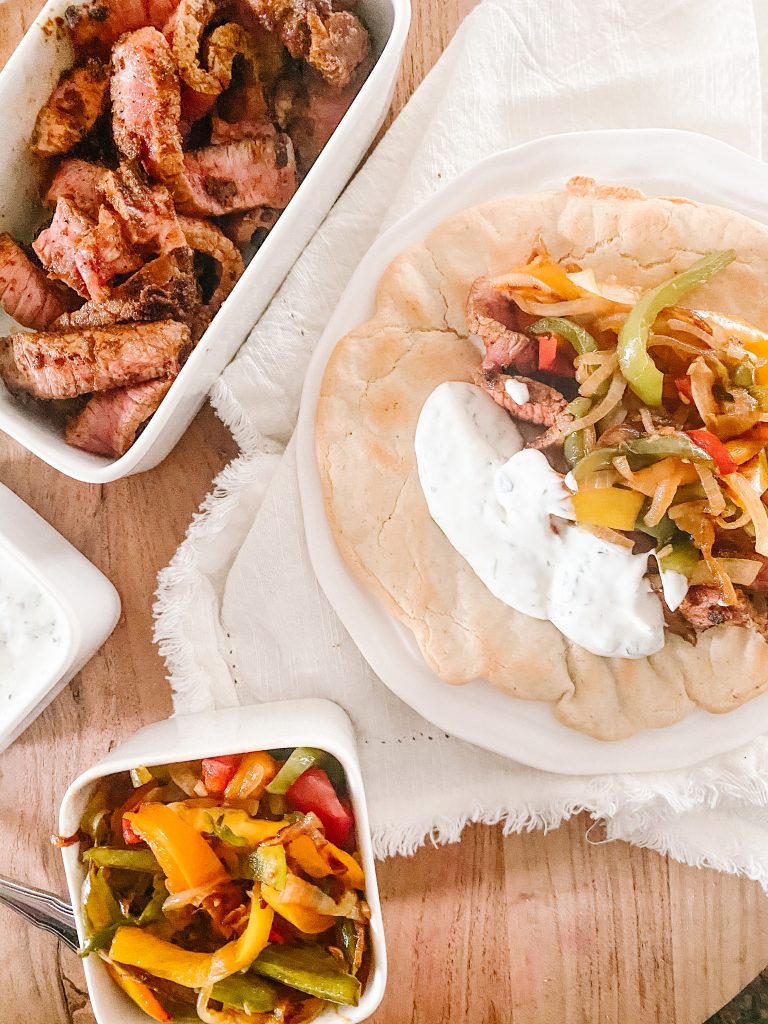 Steak Fajitas with Sautéed Bell Peppers with Lime Crema on Naan